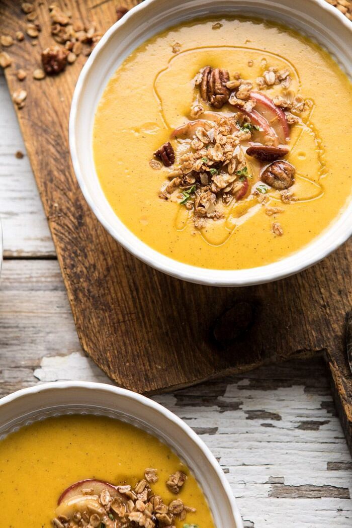 Cheddar Apple Butternut Squash Soup with Cinnamon Pecan Crumble | halfbakedharvest.com #soup #butternutsquash #autumnrecipes #thanksgiving 3/4 angled photo of Cheddar Apple Butternut Squash Soup with Cinnamon Pecan Crumble