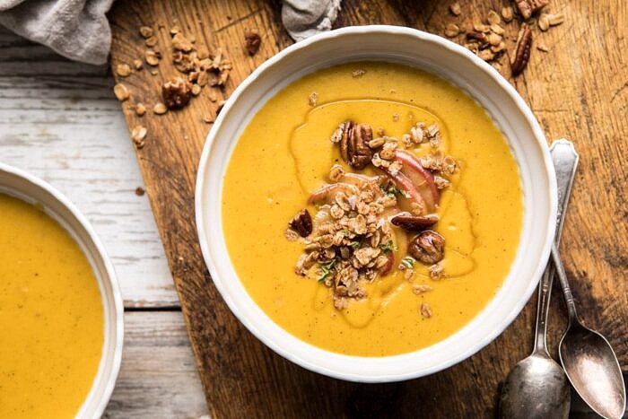 Cheddar Apple Butternut Squash Soup with Cinnamon Pecan Crumble | halfbakedharvest.com #soup #butternutsquash #autumnrecipes #thanksgiving horizontal photo of Cheddar Apple Butternut Squash Soup with Cinnamon Pecan Crumble