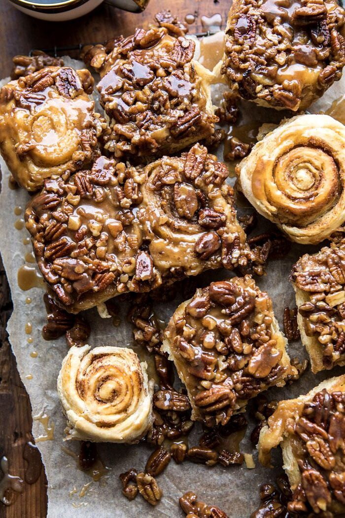 overhead photo of Extra Sticky Maple Pecan Sticky Buns with 2 buns flipped upside to show their swirl