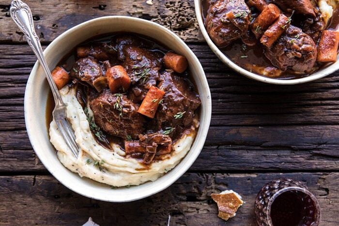 Healthier Instant Pot Coq au Vin | halfbakedharvest.com #instantpot #slowcooker #quick #easy #healthy #fallrecipes #sundaydinner horizontal photo of Healthier Instant Pot Coq au Vin with wine glass on table