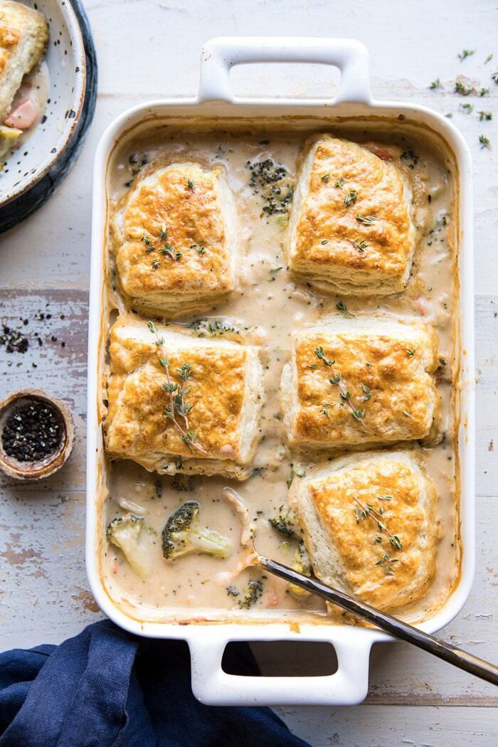 Homemade Broccoli Cheddar Cobbler | halfbakedharvest.com #broccoli #cheddar #soup #casserole #fallrecipes overhead photo of Homemade Broccoli Cheddar Cobbler with serving spoon in casserole dish