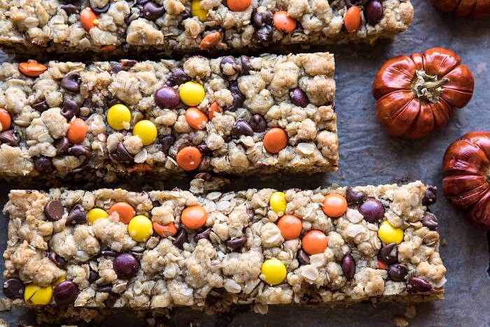 Monster Oatmeal Chocolate Chip Cookie Bars | halfbakedharvest.com #cookies #fall #autumn #halloween #thanksgiving #chocolate #easyrecipes horizontal photo of Monster Oatmeal Chocolate Chip Cookie Bars with mini pumpkins in photo