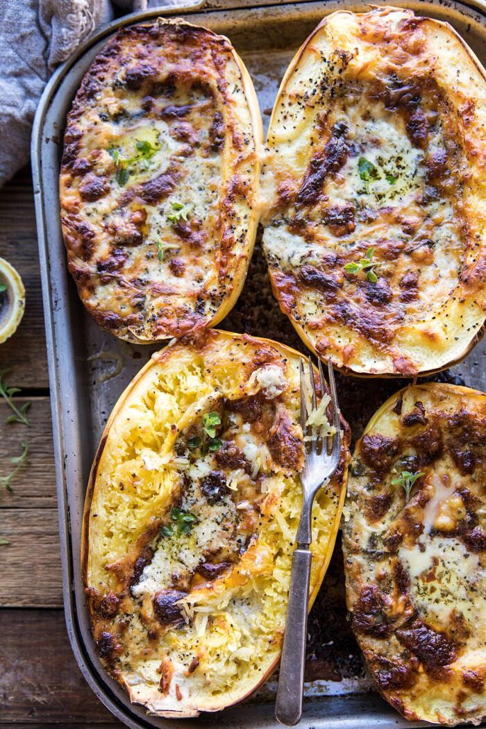 Stuffed Spaghetti Squash 4 Cheese Pesto Lasagna | halfbakedharvest.com #spaghettisquash #italian #easyrecipes #healthy #autumn #fallrecipes overhead photo of Stuffed Spaghetti Squash 4 Cheese Pesto Lasagna with fork in spaghetti squash