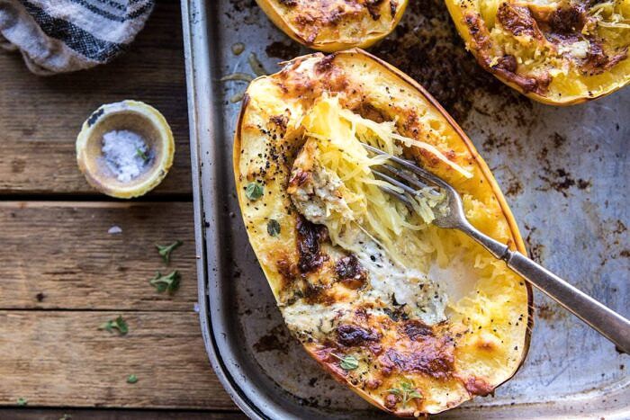 Stuffed Spaghetti Squash 4 Cheese Pesto Lasagna | halfbakedharvest.com #spaghettisquash #italian #easyrecipes #healthy #autumn #fallrecipes horizontal photo of Stuffed Spaghetti Squash 4 Cheese Pesto Lasagna with fork in spaghetti squash