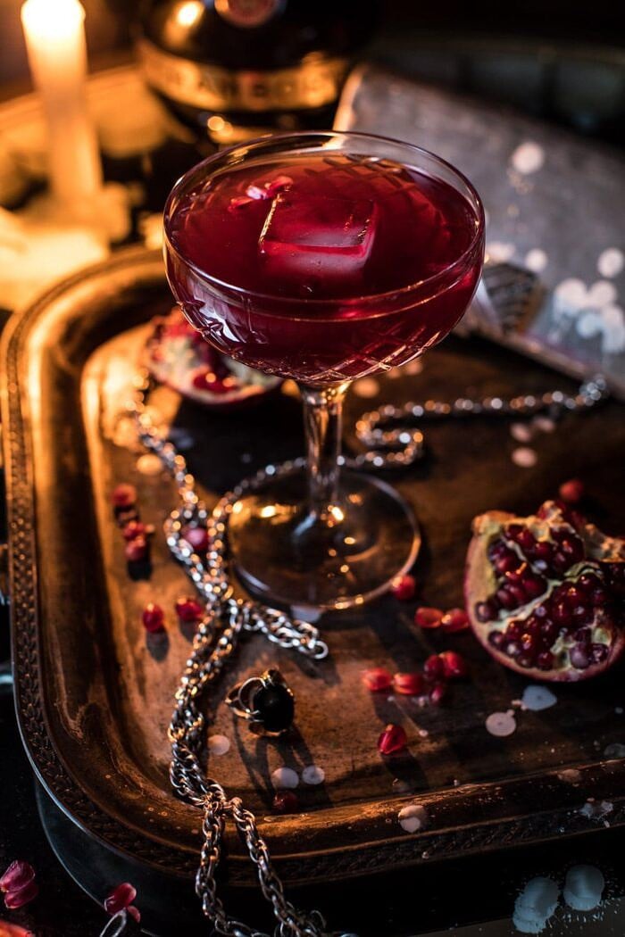 The Half Blood Prince Cocktail | halfbakedharvest.com #cocktails #halloween #pomegranate #fall #autumn close up photo of The Half Blood Prince Cocktail on serving trey