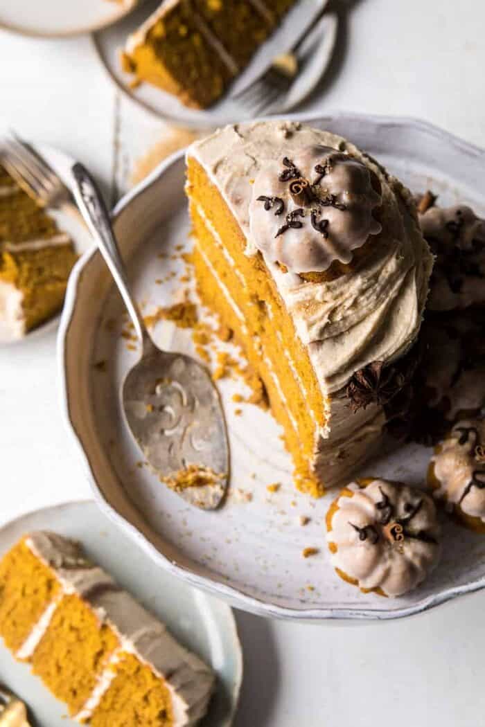 Chai Pumpkin Cake with Maple Browned Butter Frosting | halfbakedharvest.com #pumpkin #chai #fall #autumn #thanksgiving overhead photo half cut Chai Pumpkin Cake with Maple Browned Butter Frosting