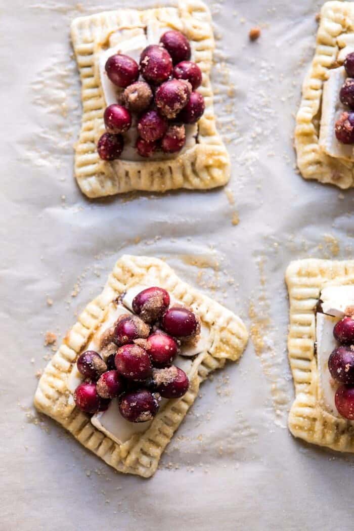 Cranberry Brie Pastry Tarts | halfbakedharvest.com #brie #cranberries #appetizers #thanksgiving #christmas overhead photo Cranberry Brie Pastry Tarts before baking