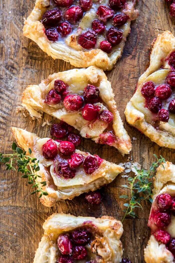 Cranberry Brie Pastry Tarts | halfbakedharvest.com #brie #cranberries #appetizers #thanksgiving #christmas overhead photo Cranberry Brie Pastry Tart cut in half