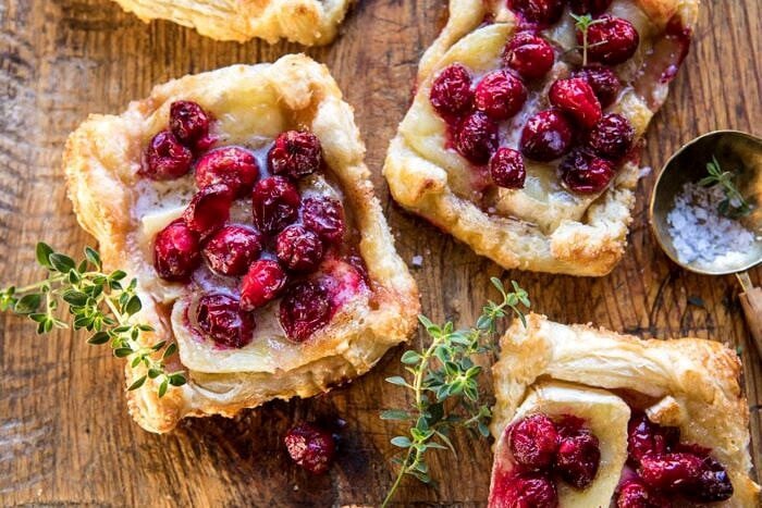 Cranberry Brie Pastry Tarts | halfbakedharvest.com #brie #cranberries #appetizers #thanksgiving #christmas horizontal photo of Cranberry Brie Pastry Tarts