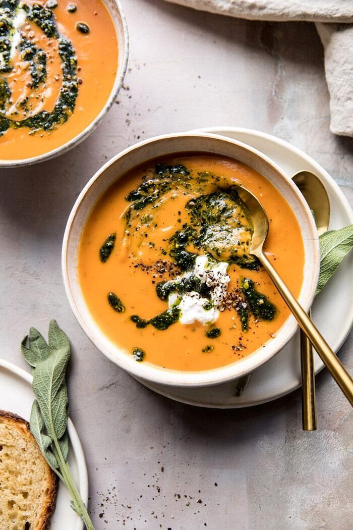 Golden Sweet Potato Soup with Burrata and Sage Pesto | halfbakedharvest.com #sweetpotato #soup #healthy #fall #autumn #winter #thanksgiving overhead photo of Golden Sweet Potato Soup with Burrata and Sage Pesto with spoon in bowl and bread on table