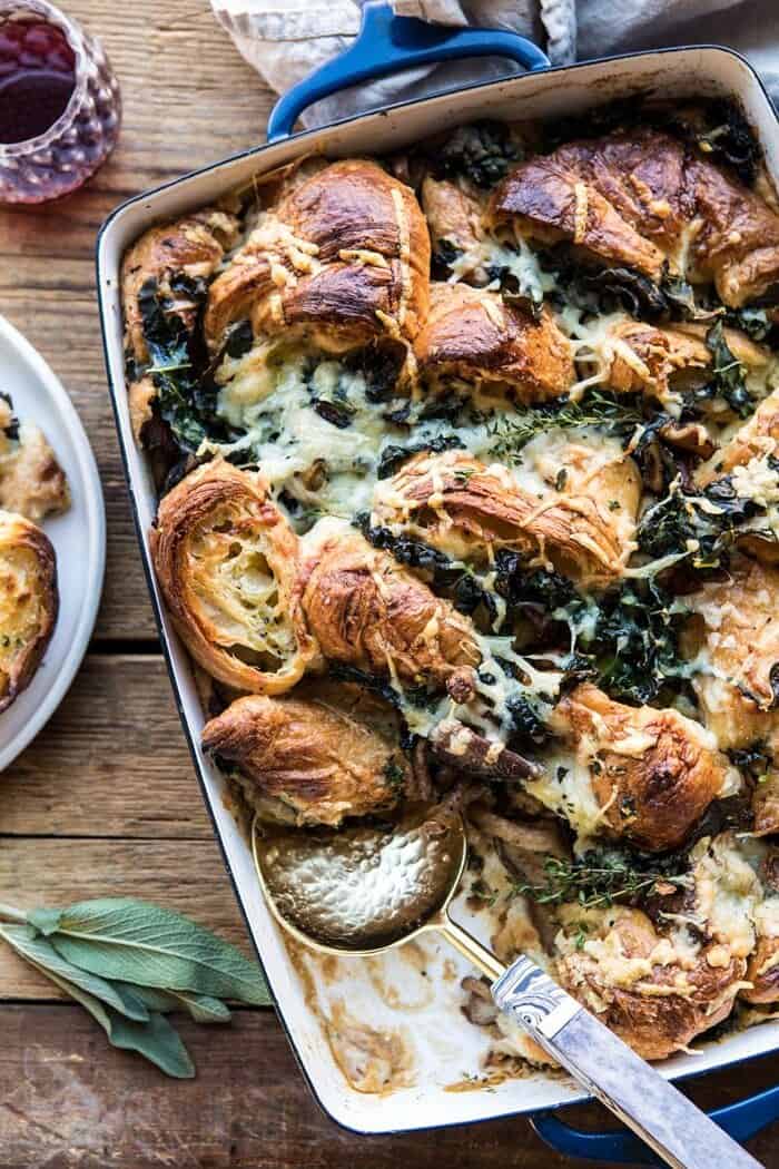 Herby Mushroom Croissant Stuffing | halfbakedharvest.com #stuffing #thanksgiving #easyrecipes #croissants overhead photo of Herby Mushroom Croissant Stuffing with spoon in casserole