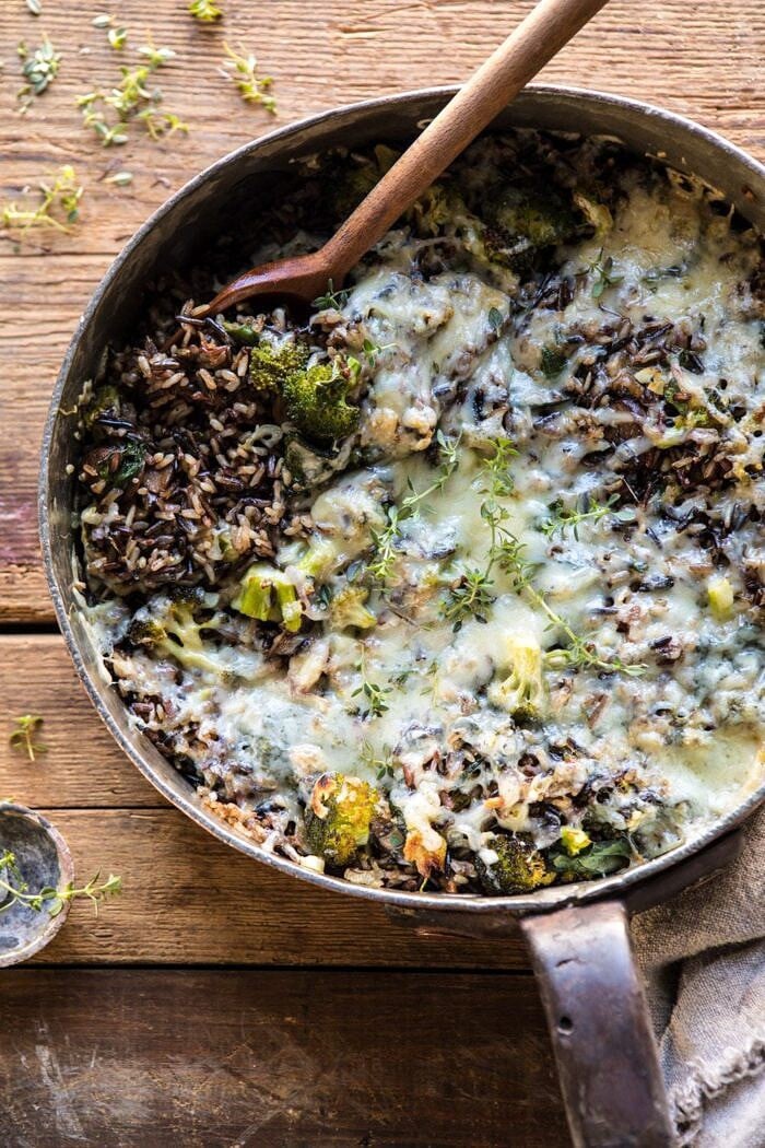 One Pan Broccoli Cheese Wild Rice Casserole | halfbakedharvest.com #wildrice #broccoli #casserole #fall #winter #easyrecipes #healthy overhead photo of One Pan Broccoli Cheese Wild Rice Casserole with spoon in pan