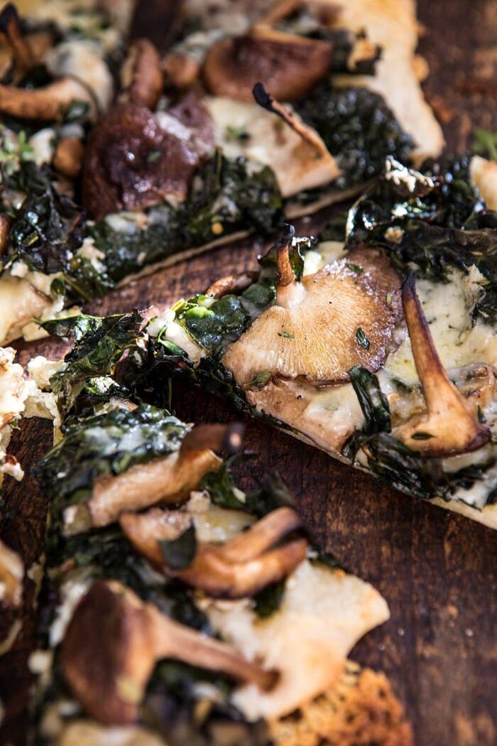 Roasted Mushroom Kale Pizza | halfbakedharvest.com #pizza #mushrooms #winter #fall #autumn #kale #Italian close up side angle photo of Roasted Mushroom Kale Pizza