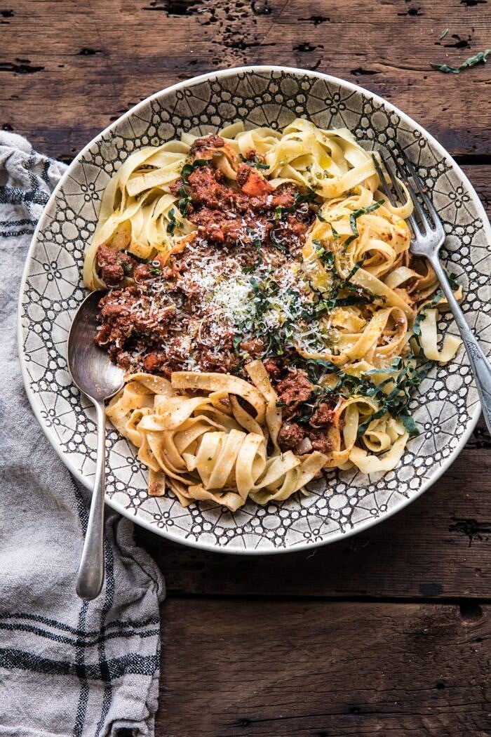 Slow Cooker Vodka Bolognese Pasta | halfbakedharvest.com #pasta #italian #bolognese #slowcooker overhead photo of Slow Cooker Vodka Bolognese Pasta with spoons in bowl
