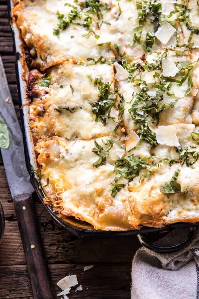 Pesto Bolognese Lasagna | halfbakedharvest.com #pasta #Italian #lasagna #cheese #holidayrecipes overhead close up photo of Pesto Bolognese Lasagna