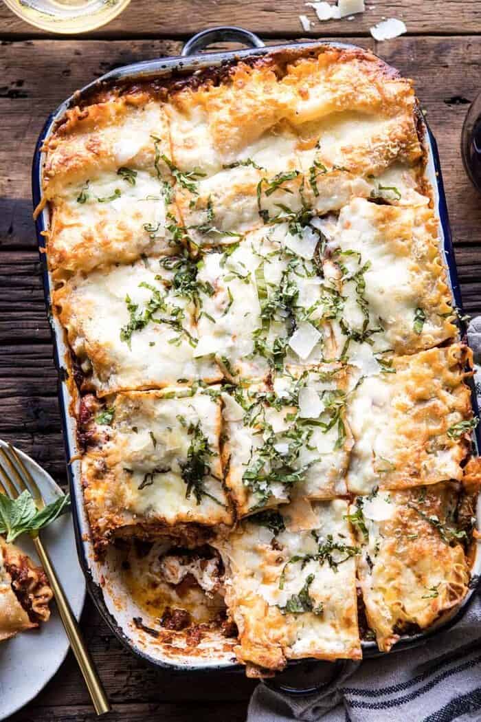 Pesto Bolognese Lasagna | halfbakedharvest.com #pasta #Italian #lasagna #cheese #holidayrecipes overhead photo of Pesto Bolognese Lasagna with cut pieces