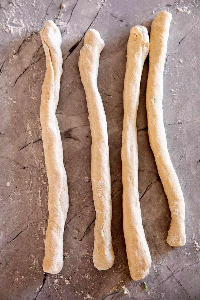 Spinach and Artichoke Stuffed Soft Pretzels | halfbakedharvest.com #softpretzels #appetizer #easyrecipes #pretzels #snacks Spinach and Artichoke Stuffed Soft Pretzel ropes before twisting into pretzels