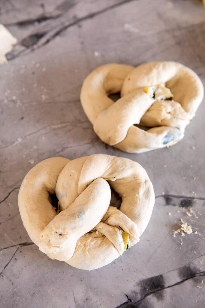 Spinach and Artichoke Stuffed Soft Pretzels | halfbakedharvest.com #softpretzels #appetizer #easyrecipes #pretzels #snacks Spinach and Artichoke Stuffed Soft Pretzels before baking