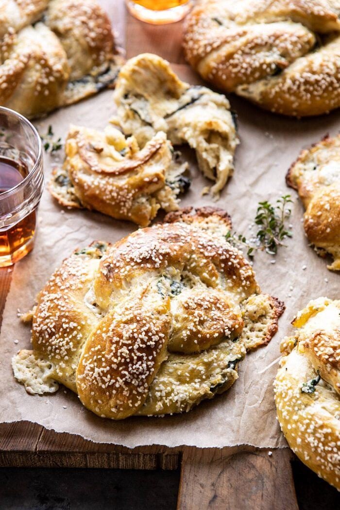 Spinach and Artichoke Stuffed Soft Pretzels | halfbakedharvest.com #softpretzels #appetizer #easyrecipes #pretzels #snacks side angle photo of Spinach and Artichoke Stuffed Soft Pretzels