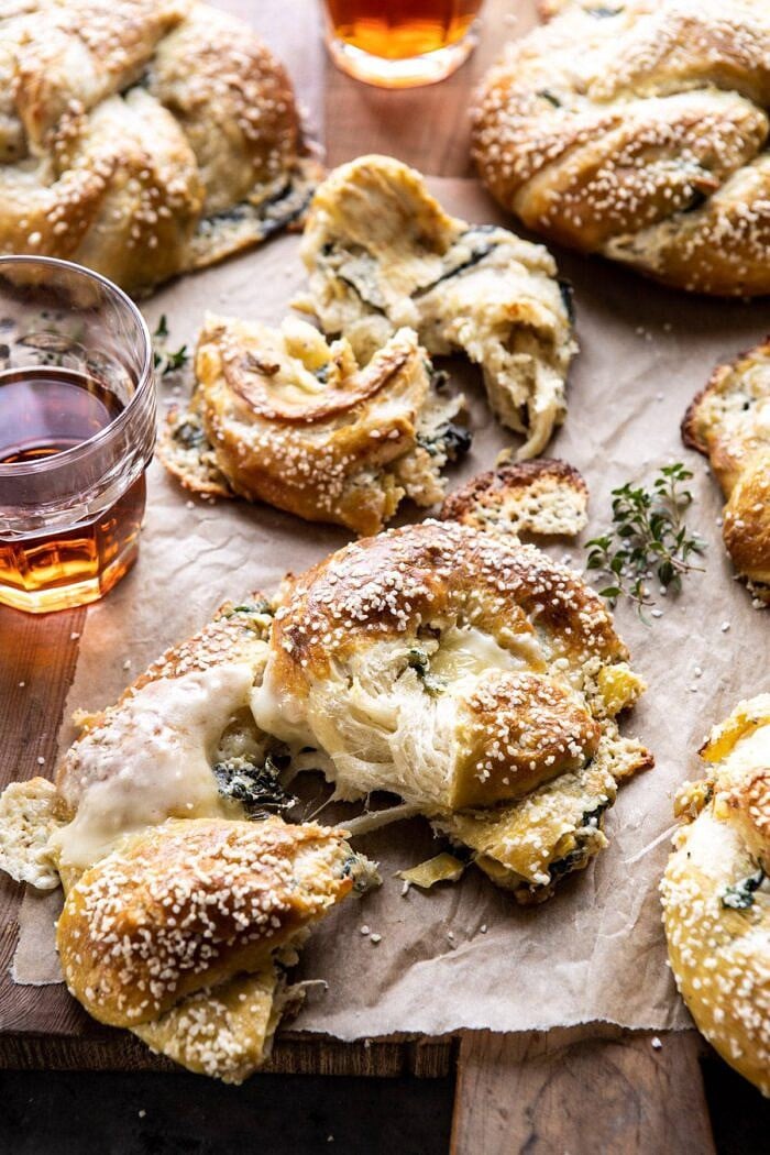 Spinach and Artichoke Stuffed Soft Pretzels | halfbakedharvest.com #softpretzels #appetizer #easyrecipes #pretzels #snacks torn apart Spinach and Artichoke Stuffed Soft Pretzels