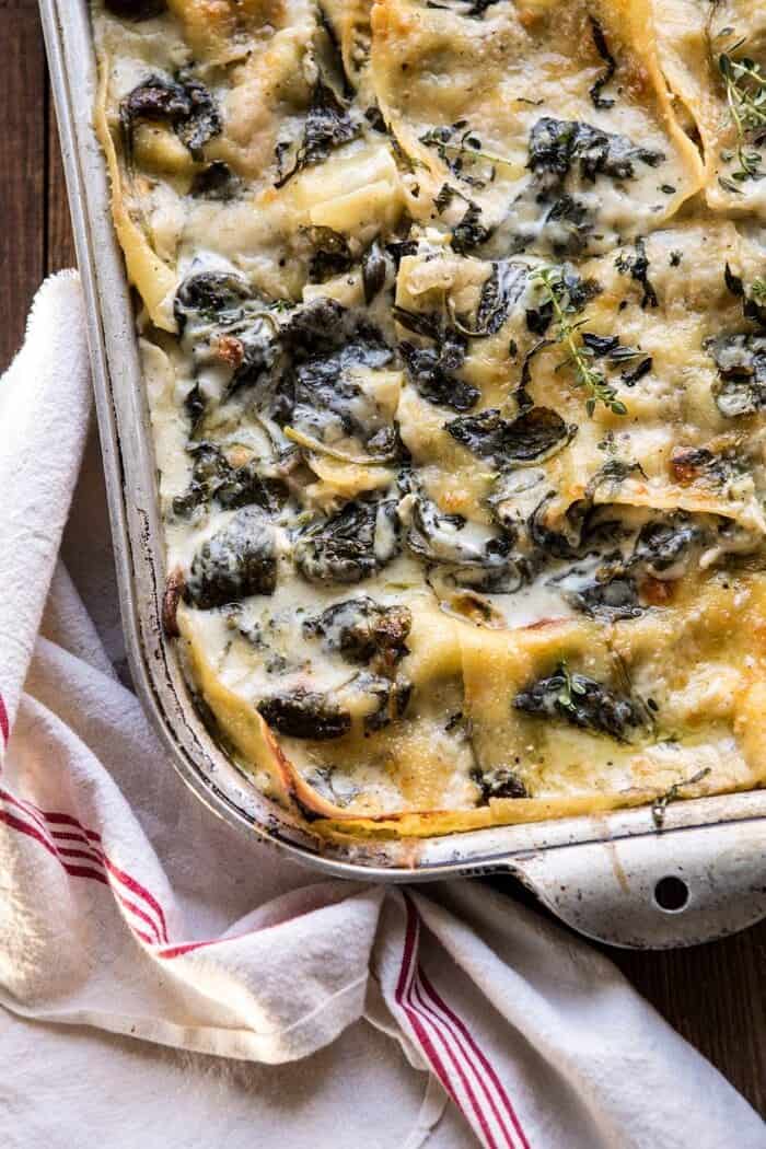 White Pesto Spinach Lasagna | halfbakedharvest.com #lasagna #pesto #italian #dinner #christmasrecipes overhead closeup side angle photo of White Pesto Spinach Lasagna
