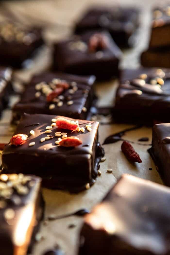 5 Ingredient Chocolate Covered Cashew Bars | halfbkaedharvest.com #chocolate #vegan #easyrecipes #dessert #healthy side angle photo of 5 Ingredient Chocolate Covered Cashew Bars