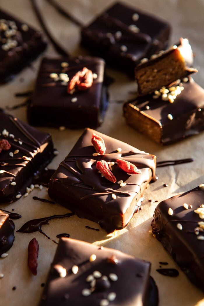 5 Ingredient Chocolate Covered Cashew Bars | halfbkaedharvest.com #chocolate #vegan #easyrecipes #dessert #healthy side angle photo of 5 Ingredient Chocolate Covered Cashew Bars