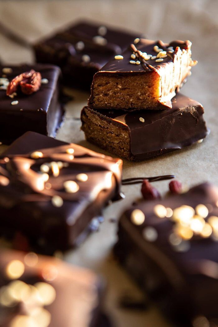 5 Ingredient Chocolate Covered Cashew Bars | halfbkaedharvest.com #chocolate #vegan #easyrecipes #dessert #healthy side angle photo of 5 Ingredient Chocolate Covered Cashew Bars cut in half