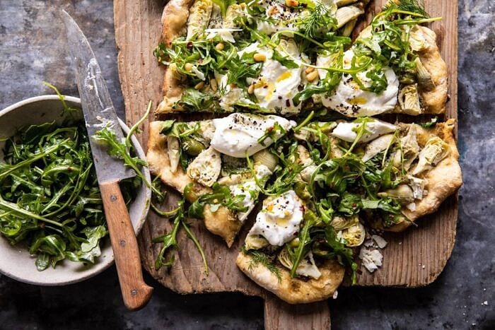 Artichoke Pesto and Burrata Pizza with Lemony Arugula | halfbakedharvest.com #pizza #healthy #burrata #easyrecipes horizontal photo of Artichoke Pesto and Burrata Pizza with Lemony Arugula