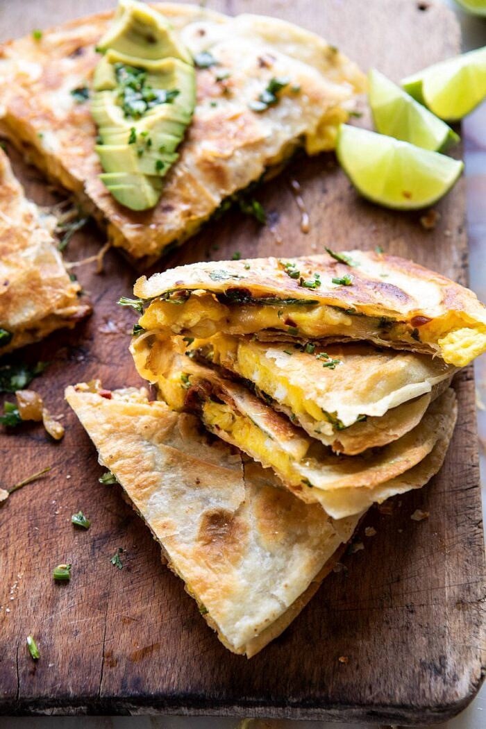 Breakfast Quesadilla with Soft Scrambled Eggs and Avocado Salsa | halfbakedharvest.com #breakfast #mexican #easyrecipes #brunch #eggs #avocado side angle photo of Breakfast Quesadilla with Soft Scrambled Eggs and Avocado Salsa