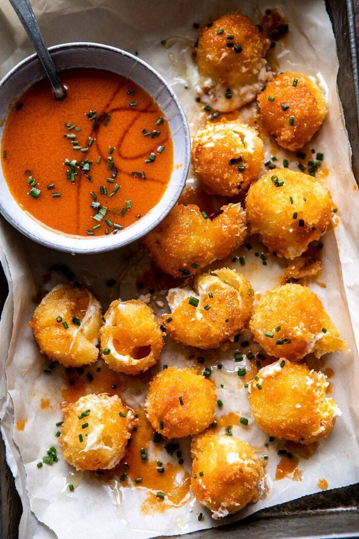Fried Buffalo Goat Cheese Balls | halfbakedharvest.com #goatcheese #appetizers #superbowl #snacks overhead photo of Fried Buffalo Goat Cheese Balls with cheese oozying out