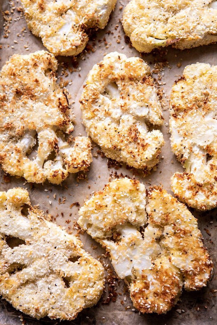 Sesame Crusted Cauliflower with Pomegranate Ponzu Sauce | halfbakedharvest.com #cauliflower #healthyrecipes #easyrecipes #vegetarian overhead photo of Sesame Crusted Cauliflower on baking sheet