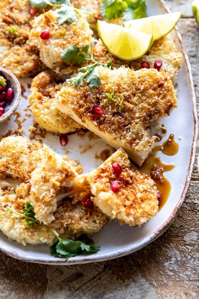 Sesame Crusted Cauliflower with Pomegranate Ponzu Sauce | halfbakedharvest.com #cauliflower #healthyrecipes #easyrecipes #vegetarian overhead photo of Sesame Crusted Cauliflower cut in half