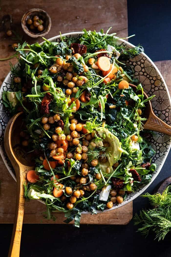 Super Green Sun-Dried Tomato Herb Salad with Crispy Chickpeas | halfbakedharvest.com #healthyrecipes #salad #easyrecipes #chickpeas #feta overhead photo of Super Green Sun-Dried Tomato Herb Salad with Crispy Chickpeas tossed in a bowl