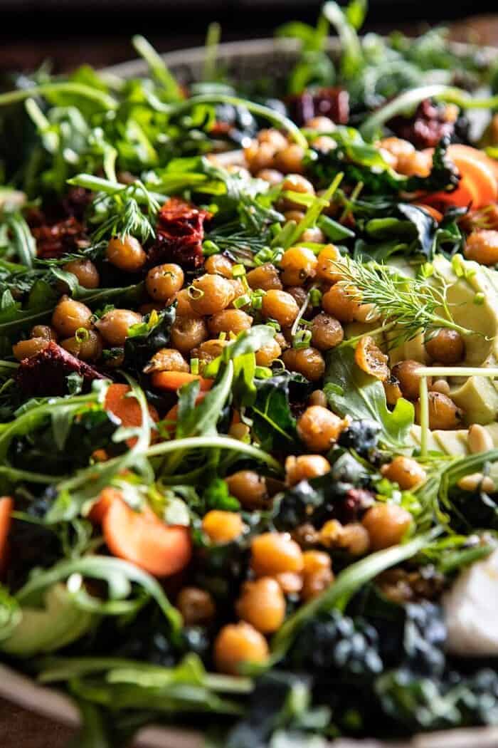 Super Green Sun-Dried Tomato Herb Salad with Crispy Chickpeas | halfbakedharvest.com #healthyrecipes #salad #easyrecipes #chickpeas #feta side angle close up photo of Super Green Sun-Dried Tomato Herb Salad with Crispy Chickpeas