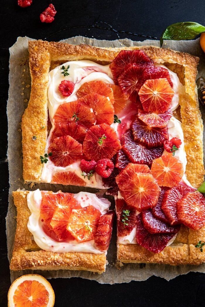 The Simplest Ombrè Citrus Cream Tart | halfbakedharvest.com #dessert #winter #citrus #healthyrecipes #easyrecipes overhead photo of The Simplest Ombrè Citrus Cream Tart with piece cut