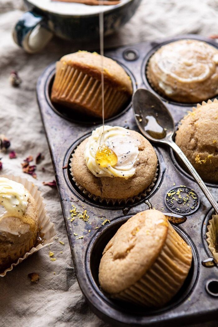 Vanilla Chai Lemon Ricotta Muffins | halfbakedharvest.com #breakfast #brunch #healthyrecipes #lemon #winter #chai side angle photo of Vanilla Chai Lemon Ricotta Muffins with honey being drizzled on