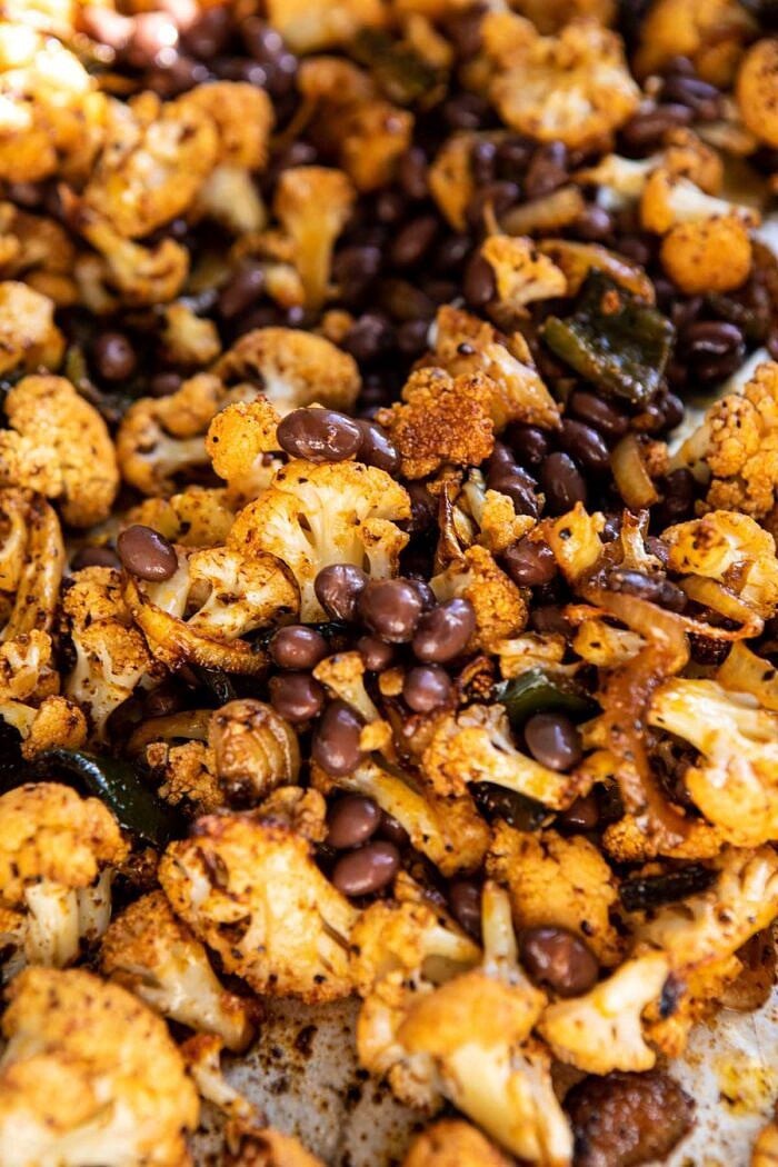 Chipotle Cheddar Cauliflower Black Bean Enchiladas | halfbakedharvest.com #mexican #vegetarian #avocado #healthy Chipotle Cheddar Cauliflower on baking sheet