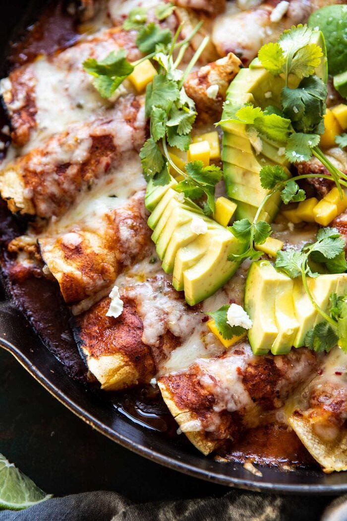 Chipotle Cheddar Cauliflower Black Bean Enchiladas | halfbakedharvest.com #mexican #vegetarian #avocado #healthy side angle close up photo of Chipotle Cheddar Cauliflower Black Bean Enchiladas