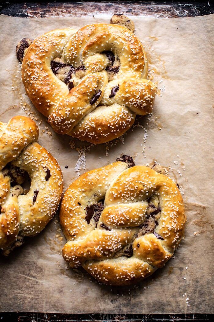 Chocolate Chip Cookie Stuffed Soft Pretzels | halfbakedharvest.com #pretzels #cookies #chocolatechipcookies #dessert #superbowl Chocolate Chip Cookie Stuffed Soft Pretzels on baking sheet after baking