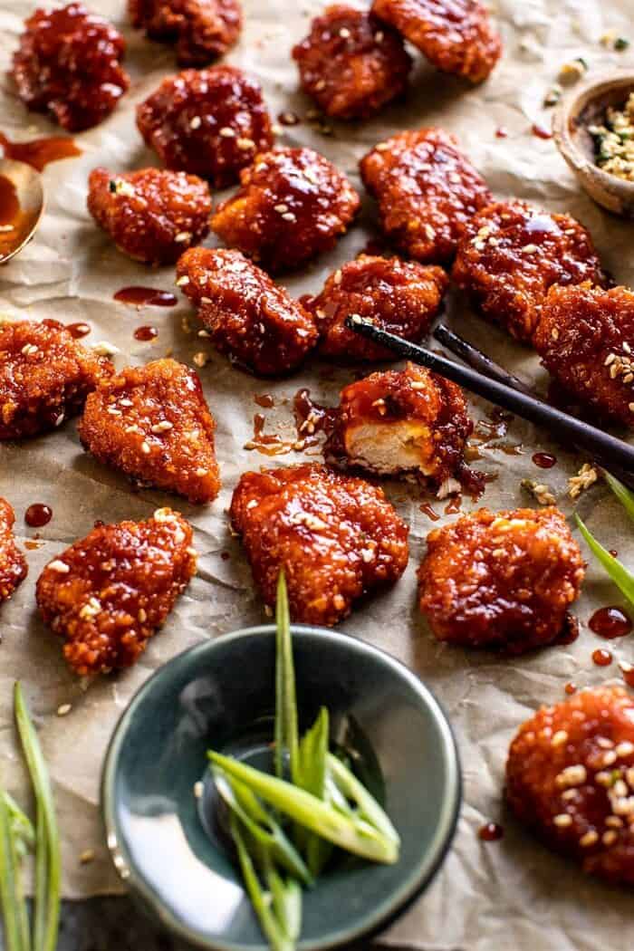 Oven Fried Korean Popcorn Chicken | halfbakedharvest.com #chicken #koreanrecipes #easyrecipes #dinnerrecipes side angled photo of Oven Fried Korean Popcorn Chicken cut in half