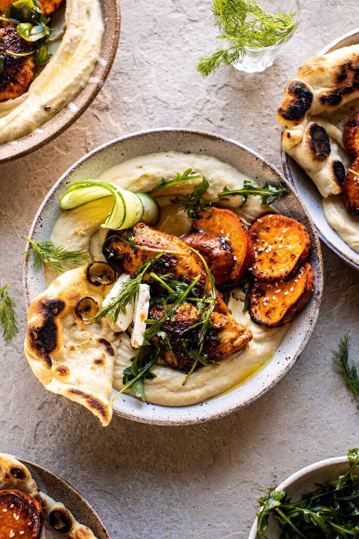 overhead close up photo of Sheet Pan Chicken Shawarma with Sesame Sweet Potatoes and Hummus