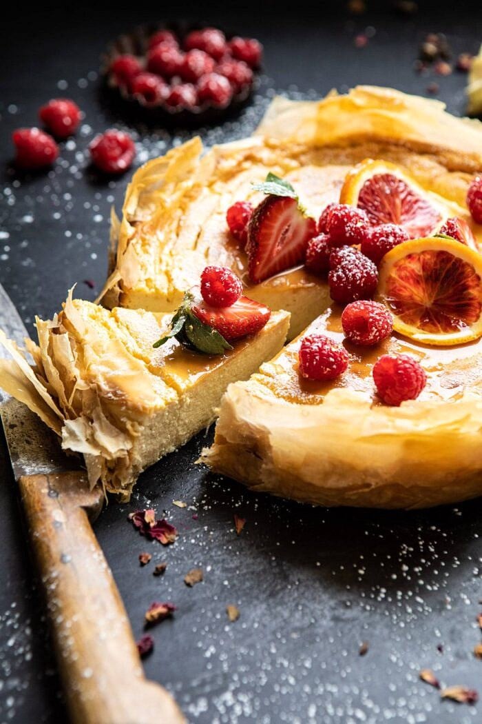 Whipped Lemon Ricotta Cheesecake | halfbakedharvest.com #cheesecake #easyrecipe #ricotta #deesert #cake #valentinesday close up side angled photo of Whipped Lemon Ricotta Cheesecake with slice cut