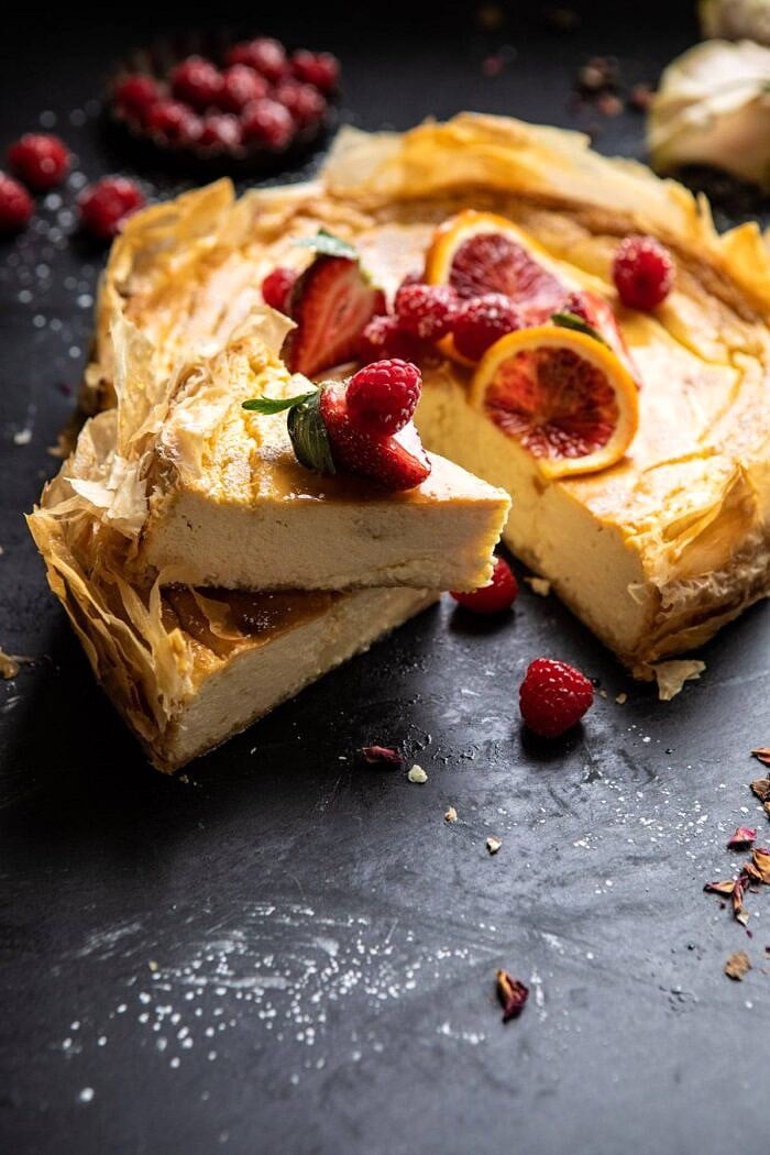 Whipped Lemon Ricotta Cheesecake | halfbakedharvest.com #cheesecake #easyrecipe #ricotta #deesert #cake #valentinesday Whipped Lemon Ricotta Cheesecake with 2 slices cut and stacked on top of each other