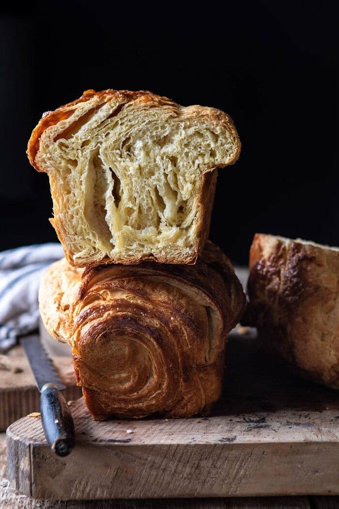Flaky Honey Brioche Bread stack one on top of each other and cut in half