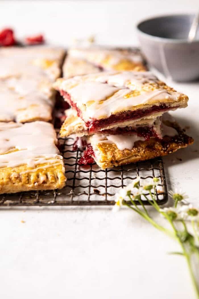 Giant Strawberries n' Cream Pop Tart | halfbakedharvest.com #brunch #pie #dessert #breakfast side angle of Giant Strawberries n' Cream Pop Tart cut into pieces and stacked