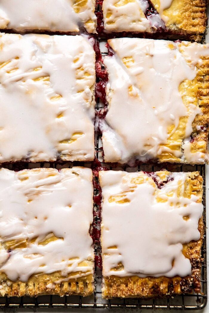 Giant Strawberries n' Cream Pop Tart | halfbakedharvest.com #brunch #pie #dessert #breakfast overhead close up photo of Giant Strawberries n' Cream Pop Tart