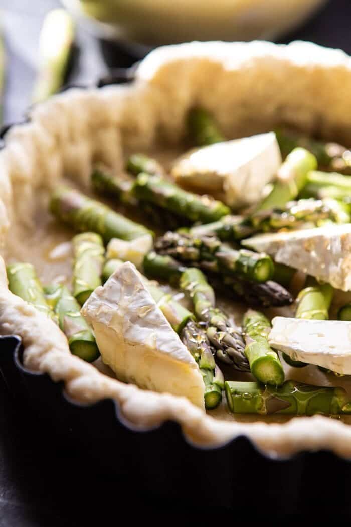 Asparagus and Brie Quiche | halfbakedharvest.com #quiche #brunch #springrecipes #easter side angle photo of Asparagus and Brie before baking