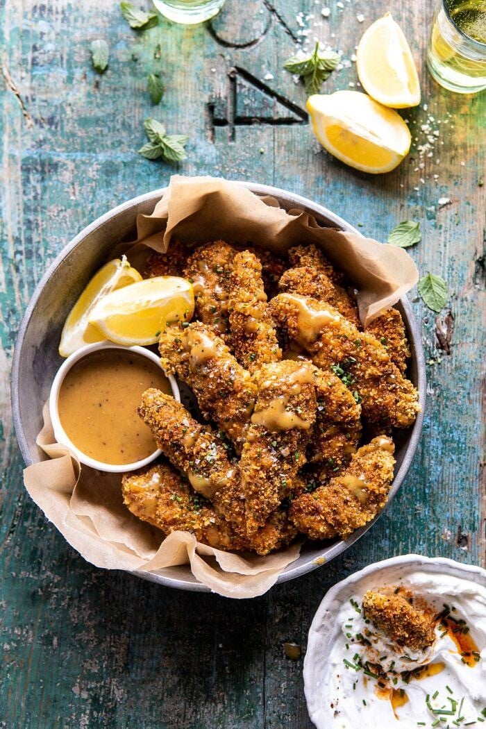 Baked Black Pepper Ranch Chicken Fingers with Honey Mustard | halfbakedharvest.com #chicken #easyrecipes #dinner #chickenfingers overhead photo of Baked Black Pepper Ranch Chicken Fingers with Honey Mustard in serving bowl