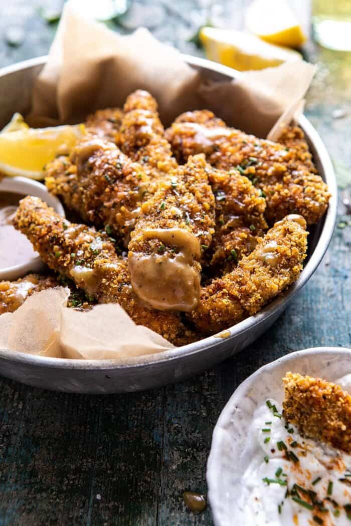 Baked Black Pepper Ranch Chicken Fingers with Honey Mustard | halfbakedharvest.com #chicken #easyrecipes #dinner #chickenfingers side angle close up photo of Baked Black Pepper Ranch Chicken Fingers with Honey Mustard